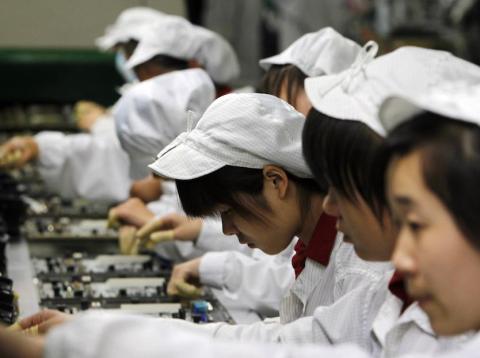Workers in a Foxconn factory in China. Workers in a Foxconn factory in China.