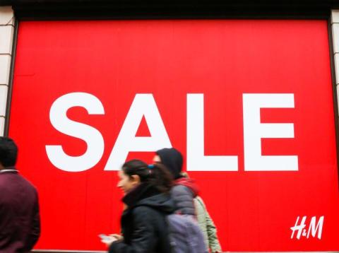 Shoppers are seen walking past H&M window display with a large SALE sign. Last minute Christmas shoppers take advantage of pre-Christmas bargains at Oxford Street in London. Fewer shoppers have been reported shopping in Britain's Shoppers are seen walking past H&M window display with a large SALE sign. Last minute Christmas shoppers take advantage of pre-Christmas bargains at Oxford Street in London. Fewer shoppers have been reported shopping in Britain's