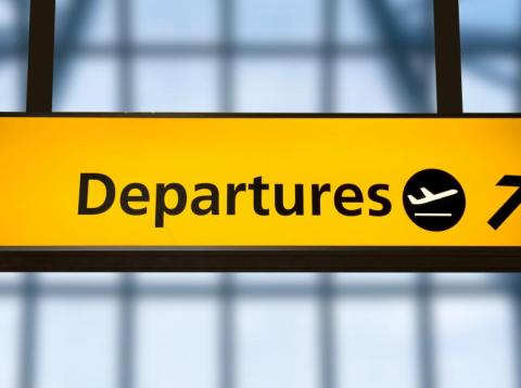 A sign for departures at Gatwick Airport, UK. A sign for departures at Gatwick Airport, UK.
