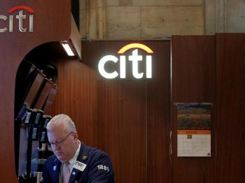 Citi trader Thomas Ferrigno works in his company's booth on the floor of the New York Stock Exchange (NYSE) in New York City, U.S., July 27, 2016. Citi trader Thomas Ferrigno works in his company's booth on the floor of the New York Stock Exchange (NYSE) in New York City, U.S., July 27, 2016.