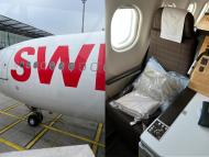 the front of a swiss airplane next to a photo of a business-class seat