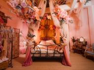 The room has been transformed into a Belle Époque inspired boudoir, reminiscent of the cabaret era.