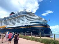 The Disney Wish cruise ship docked on Disney's private island Castaway Cay.